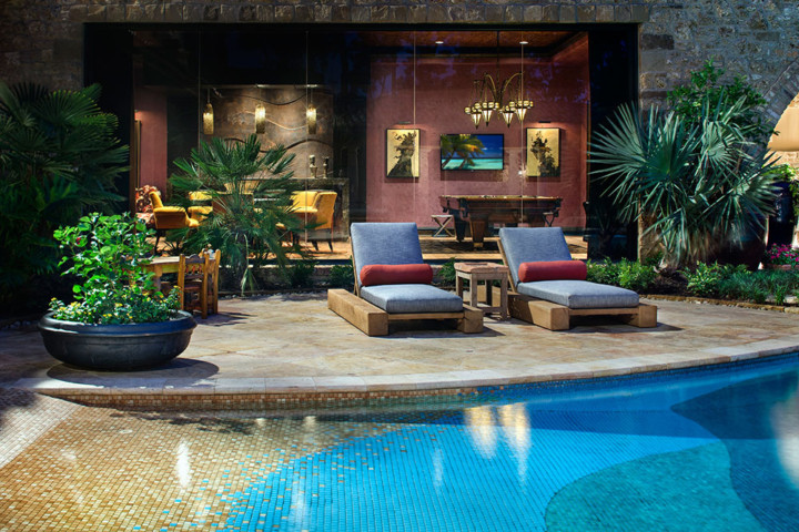 A pool with two lounge chairs and a table