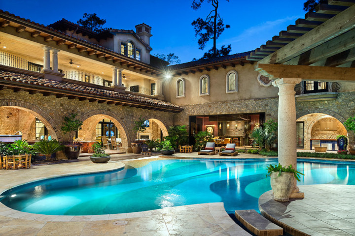 A large pool with a nice view of the house.