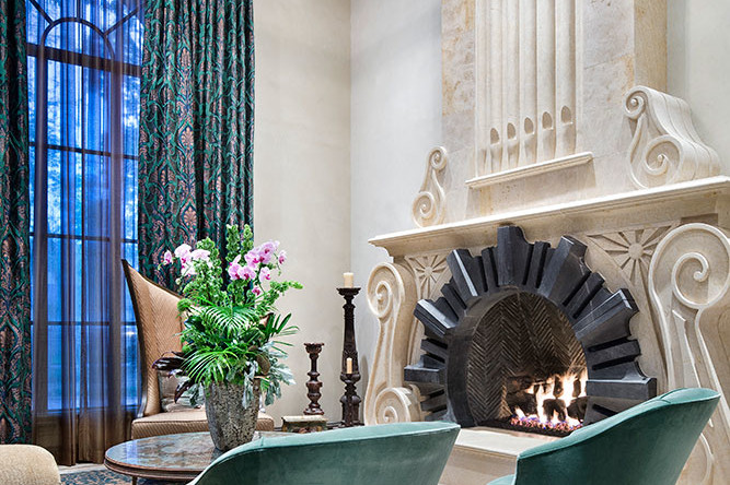 A living room with two chairs and a fireplace