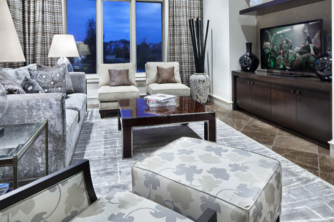 A living room with a couch, chair and television.