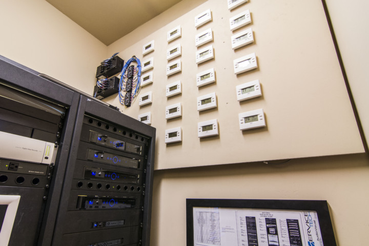 A wall with many different electrical outlets on it