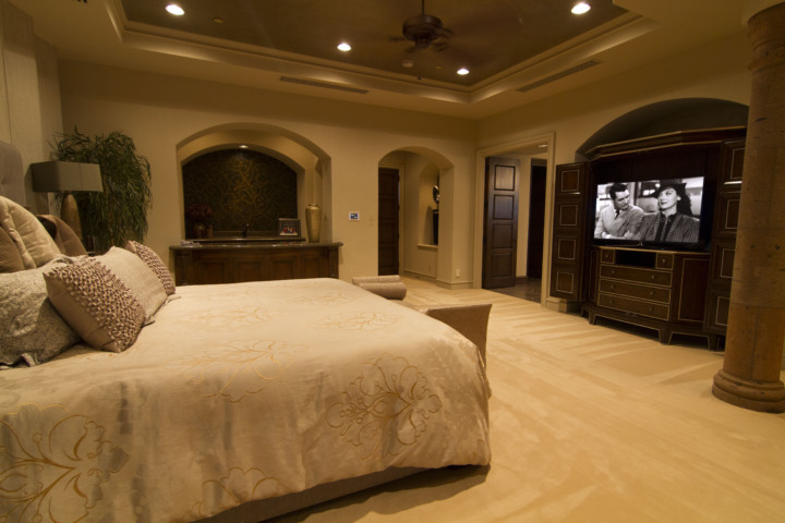 A bedroom with a bed and tv in it