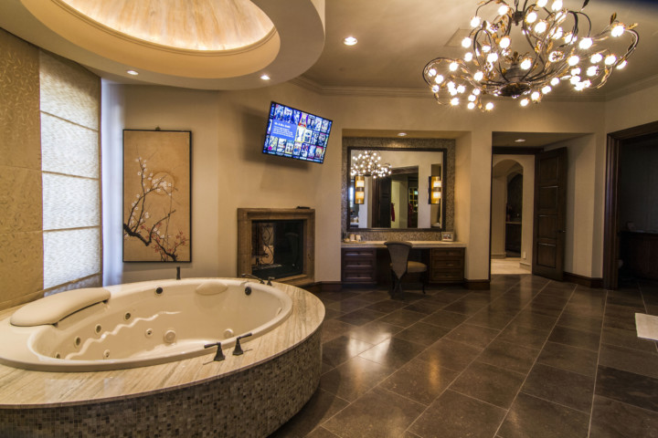 A large bathroom with a jacuzzi tub and fireplace.