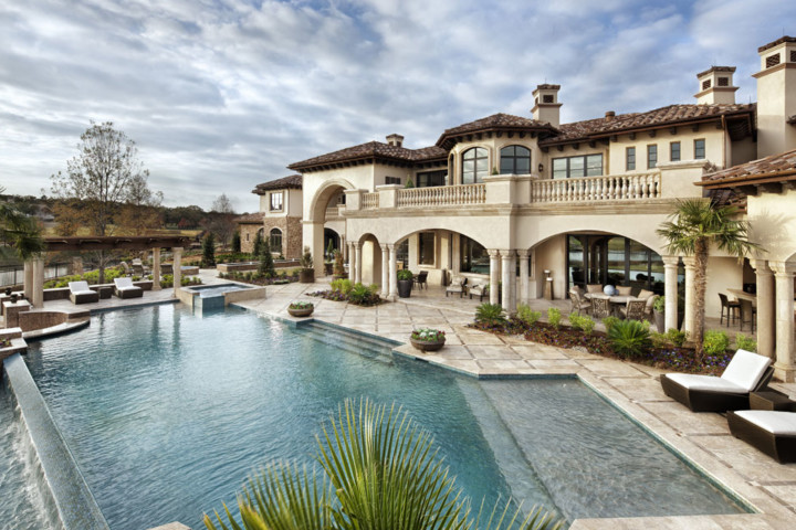 A large pool with a nice house in the background