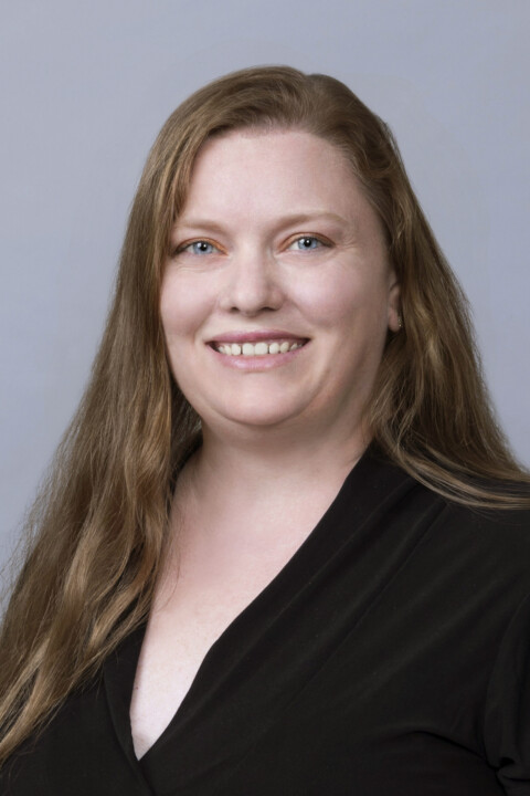 A woman with long hair wearing black shirt