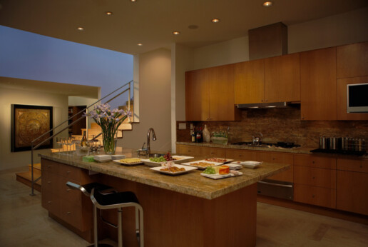 a kitchen counter with food on it illuminated by dimmed orange lights