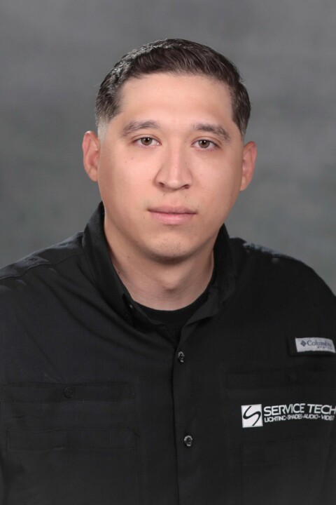 A man in black shirt and white logo.