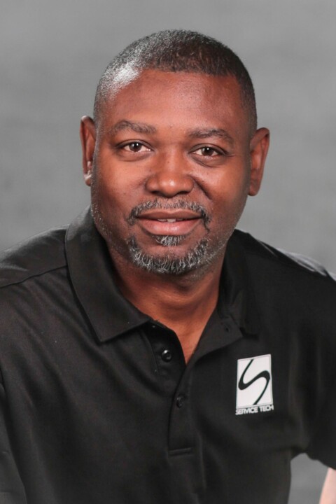 A man in black shirt and white logo.