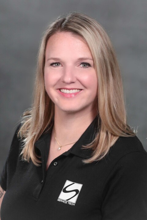 A woman in black shirt smiling for the camera.