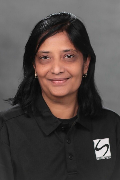 A woman in black shirt smiling for the camera.