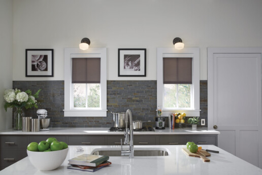 A luxury kitchen featuring Lutron motorized shades.